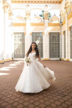 mutlu güzel gelin düğün makyajı ve saç gelin gün gülümseyerek ve damat için bekliyor. Düğün için son hazırlık ve sunuş çekici yeni evli kadın var. çok güzel bir gelin. mutlu zengin gelin.