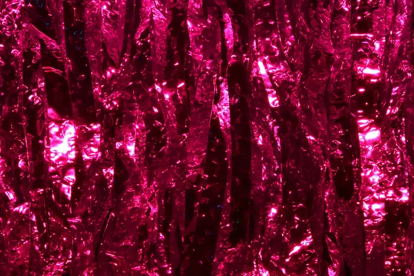 Plastic sheet metal shiny. When it hits light it will reflect.Put together Use as a beautiful backdrop. Feel like a pink metal curtain.