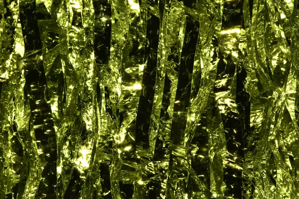 Plastic sheet metal shiny. When it hits light it will reflect.Put together Use as a beautiful backdrop. Feel like a green metal curtain.