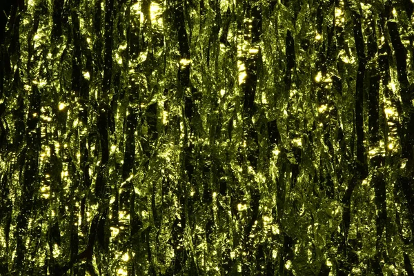 Plastic sheet metal shiny. When it hits light it will reflect.Put together Use as a beautiful backdrop. Feel like a green metal curtain.