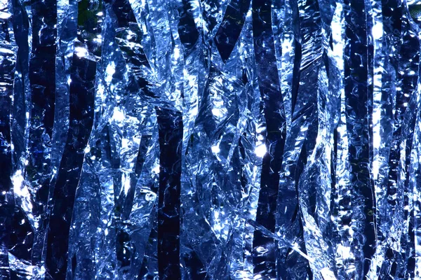 Plastic sheet metal shiny. When it hits light it will reflect.Put together Use as a beautiful backdrop. Feel like a blue metal curtain.