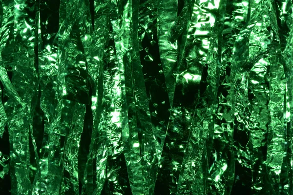 Plastic sheet metal shiny. When it hits light it will reflect.Put together Use as a beautiful backdrop. Feel like a green metal curtain.