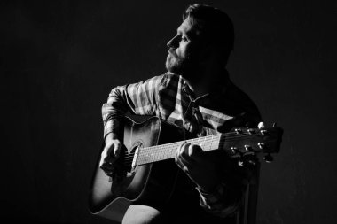 Sad Caucasian male musician playing guitar on stage, focus on hand. black and white. clipart
