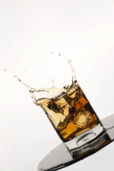 Tilted Glass Splashing Whiskey Ice Isolated White — Stock Photo, Image