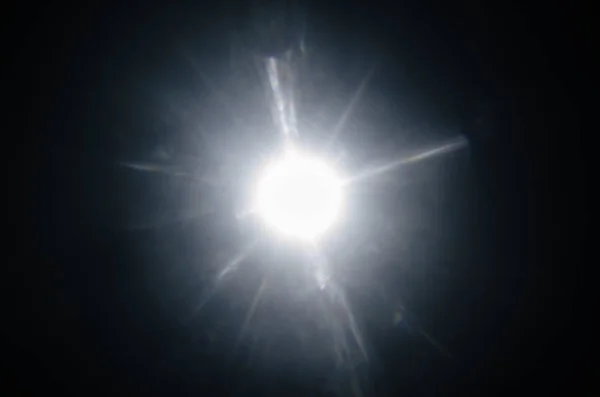 Abstract Natural Sun flare or Far star on the black background
