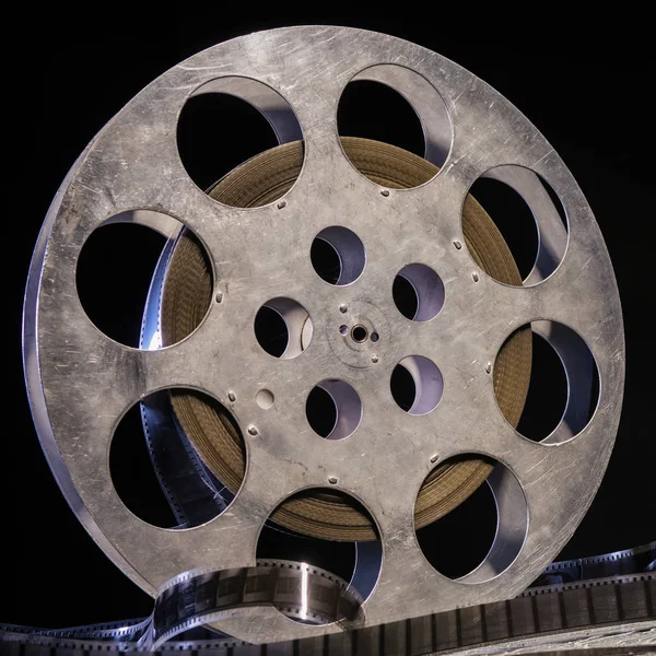 stock image 35 mm film reel with dramatic lighting on a dark background