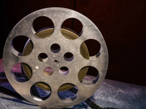 stock image 35 mm film reel with dramatic lighting on a dark background