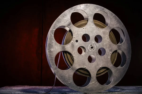 stock image 35 mm film reel with dramatic lighting on a dark background