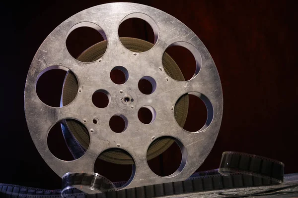 stock image 35 mm film reel with dramatic lighting on a dark background