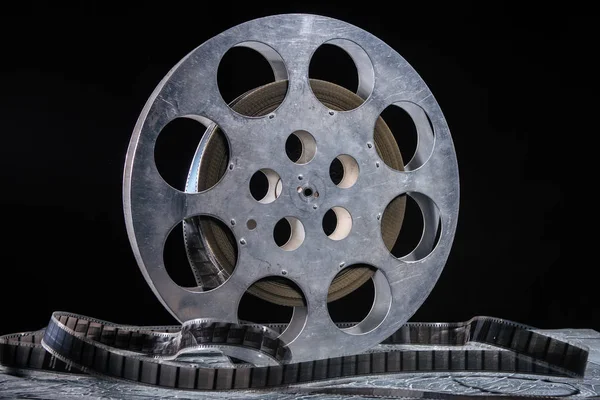 stock image 35 mm film reel with dramatic lighting on a dark background