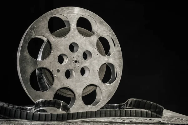 stock image 35 mm film reel with dramatic lighting on a dark background
