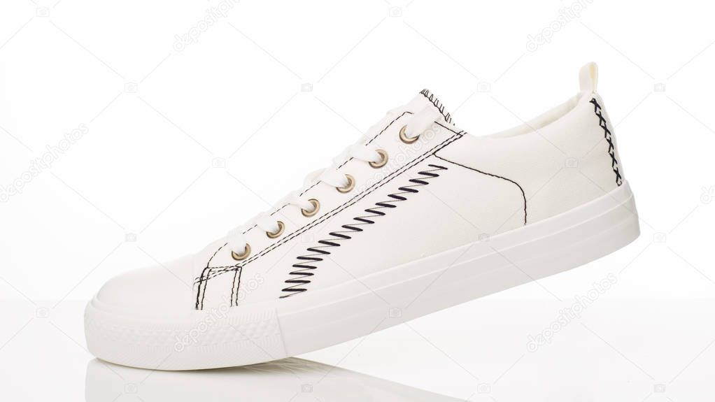Fashionable white walking shoes on a white background.