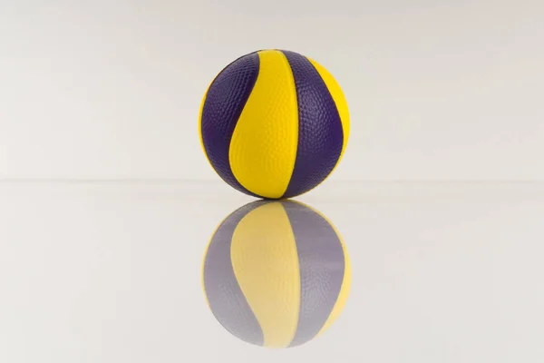 Basketball ball with yellow and purple spots on a white background. Antistress ball