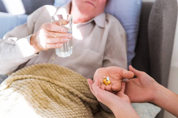 Close Old Sick Man Lying Bed Home Holding Pills Water — Stock Photo, Image