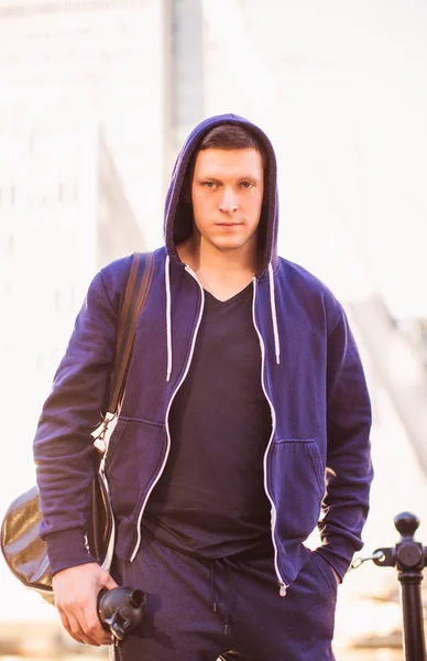 Portrait of young sporty man who going outdoor and holding sporty bag and bottle