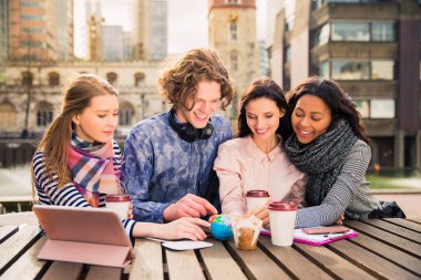 Çekici öğrenci grubu oturup globe adlı bir ara, açık havada zamanında bakmak