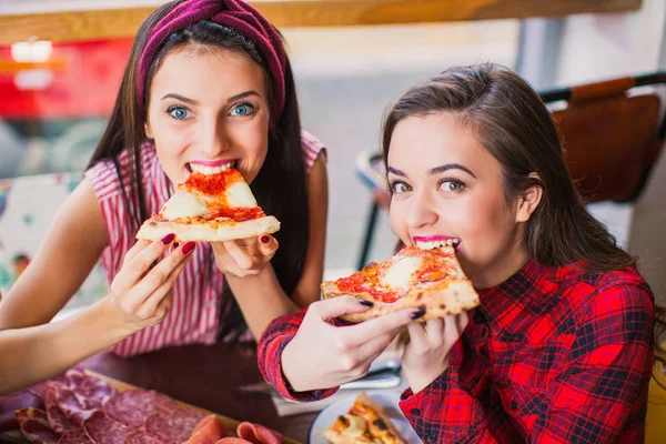 Two Happy Women Sit Table Keep Slices Pizza Hands Bite — Stock Photo, Image