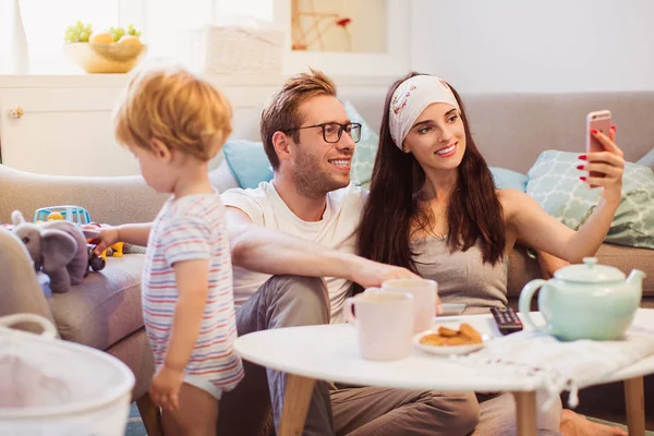 Die Jungen Fröhlichen Eltern Die Tisch Auf Dem Fußboden Zimmer — Stockfoto