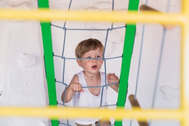 Neşeli küçük çocuk yukarı kapalı merdiven tarafından tırmanma