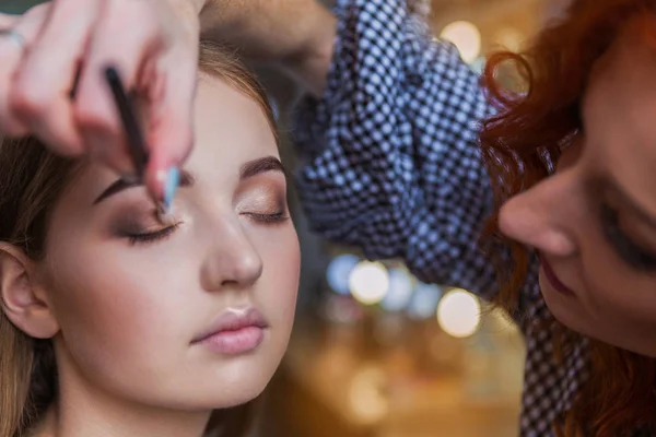 Cerrar Artista Maquillaje Feliz Aplicando Sombra Ojos Hermosa Mujer Joven —  Fotos de Stock