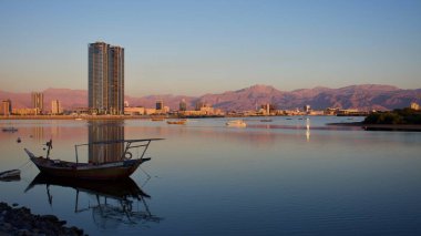 Ras Al Khaimah şehirde akşam günbatımında net açık mor renkli dağ manzaralı Jebal Jais Hacer Dağları'nda doğru Corniche, Birleşik Arap Emirlikleri. 