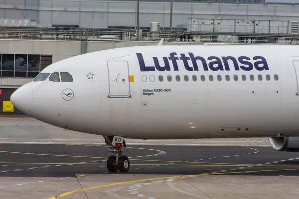 White Lufthansa Airbus airplane driving into the Frankfurt Airport on the tarmac.