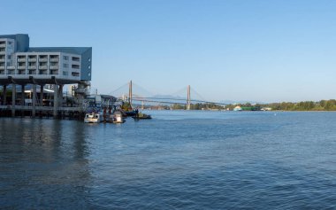 Skytrain köprüsü, Patullo ve New Westminster, British Columbia, Kanada'daki dağlara bakan Fraser Nehri üzerinde akşam yaz gün batımı.