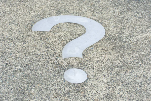 White Question mark on concrete concept - decisions, uncertainty, choice in life or business. Copy space. Angled.