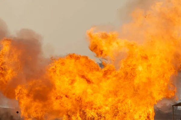 Massive orange fire explosion in military combat and war. Vehicle explosion from a tank in a city in the Middle East. Military Concept. Strength, power, explosion.