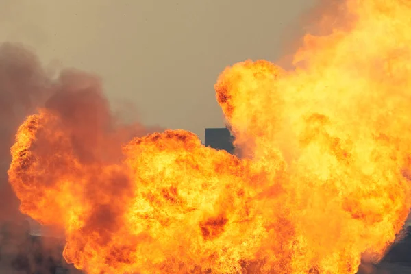 Massive orange fire explosion in military combat and war. Vehicle explosion from a tank in a city in the Middle East. Military Concept. Strength, power, explosion.