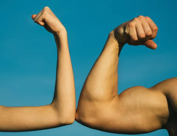 Competition, strength comparison. Vs. Fight hard. Health concept. Hand, man arm, fist. Musclar arm vs weak hand