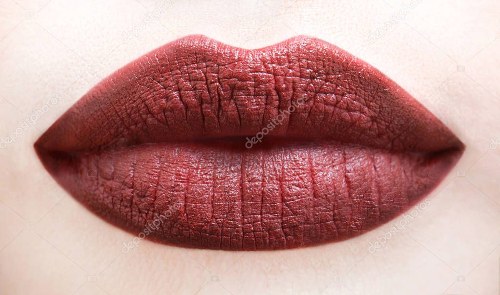 Sexy lips. Brown lip. Close up of sexy plump soft lips with dark brown lipstick. Professional makeup lip gloss cosmetic product. Face skin mouth perfection flawless concept. Lip care and beauty