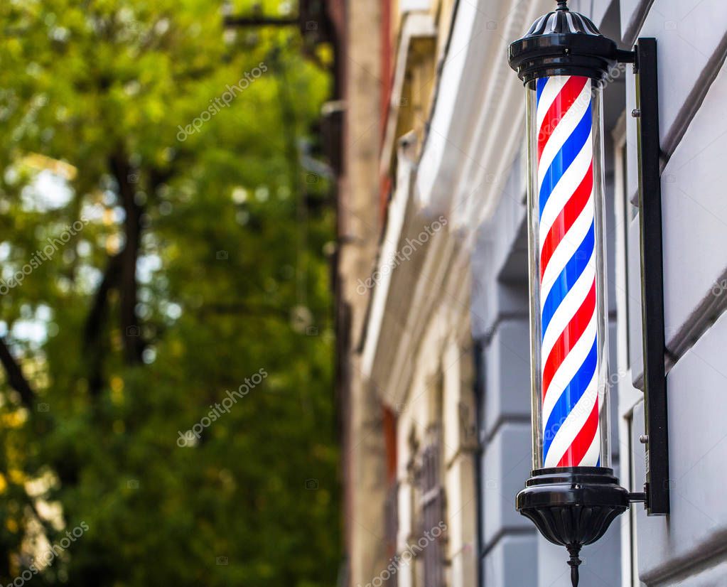 Barber shop pole. Logo of the barbershop, symbol. Barbershop pole, retro. Copy space. Old fashioned vintage barber shop pole. A classic barber logo. Bearded man.