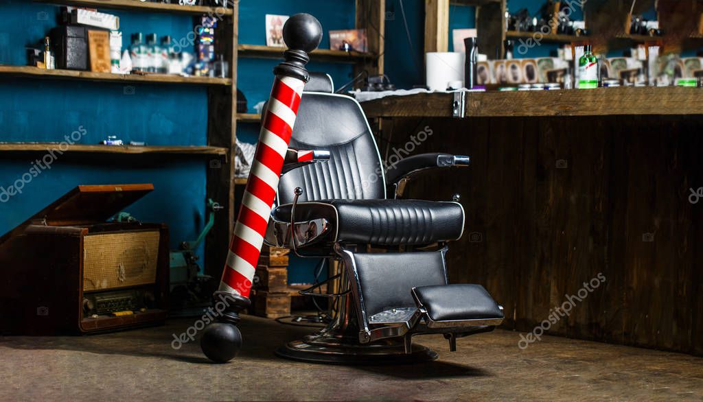 Barber shop pole. Logo of the barbershop, symbol. Stylish vintage barber chair. Hairstylist in barbershop interior. Barber shop chair. Barbershop armchair, hairdresser, hair salon, barber shop for men