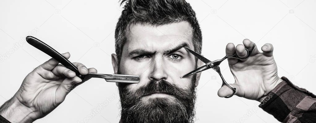 Bearded man, bearded male. Portrait of stylish man beard. Barber scissors and straight razor, barber shop. Vintage barbershop, shaving