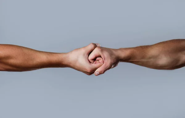 Two hands, isolated arm, helping hand of a friend. Friendly handshake, friends greeting. Rescue, helping hand. Male hand united in handshake. Man help hands, guardianship, protectio — Stock Photo, Image