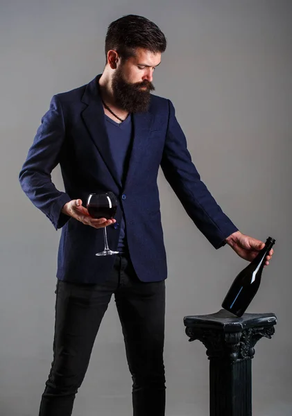 Bottle, red wine glass. Beard man, bearded, sommelier, tasting. Red wine in bottle, wineglass. Waiter, red wine in a glas. Sommelier man, degustator, winery, male winemake