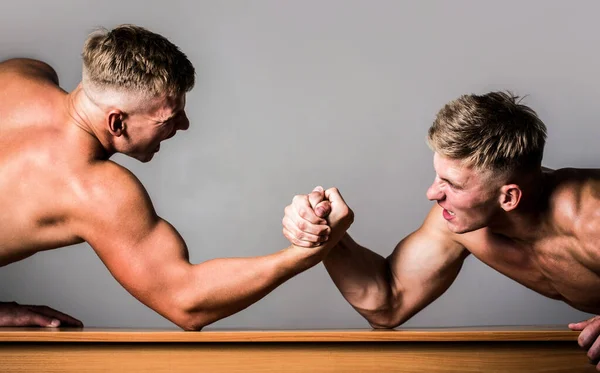 Men measuring forces, arms. Hand wrestling, compete. Hands or arms of man. Muscular hand. Arm wrestling. Two men arm wrestling. Rivalry, closeup of male arm wrestling. Two hands