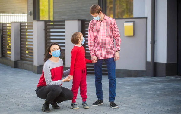 Mom dad and sat down went for a walk in worn masks. Family wearing medical mask. Family in protective mask, medical mask. Coronavirus, illness, infection, quarantine, medical masks, COVID-19