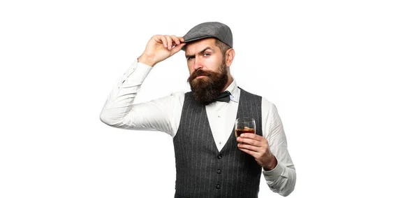 Stylowy bogacz trzymający szklankę starej whisky. Brodaty dżentelmen pije koniak. Łyk najlepszej whisky. Portret mężczyzny z gęstą brodą. Macho pije. — Zdjęcie stockowe