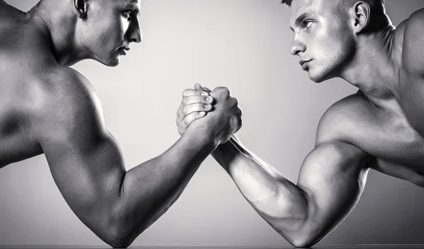 Hand wrestling, compete. Hands or arms of man. Muscular hand. Clasped arm wrestling. Two men arm wrestling. Rivalry, closeup of male arm wrestling. Two hands. Muscular men measuring forces, arms — Stock Photo, Image