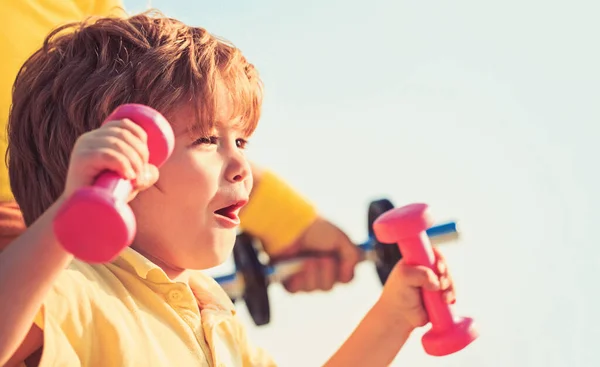Sporty boy with dumbbells. Sport. Fitness, health and energy. Cheerful boy do exercises with dumbbells. Kid exercising with dumbbells. Fitness child. Sport for little children. Healthy lifestyle — Stock Photo, Image