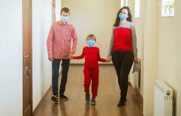 Coronavirus epidemic. Parents and kid wearing a surgical masks. Coronavirus outbreak. Family wearing safety medical masks. Prevention coronavirus. Stay at home. Home quarantine