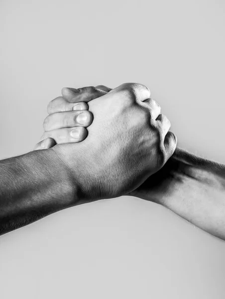 Two hands, isolated arm, helping hand of a friend. Handshake, arms. Friendly handshake, friends greeting. Male hand united in handshake. Black and white — Stock Photo, Image