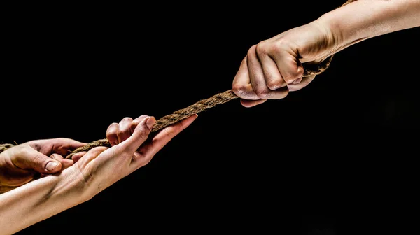 Conflict, tug-of-war, rope. Hand holding a rope, climbing rope, strength and determination concept. Safety. Macro shot isolated over black background. — Stock Photo, Image