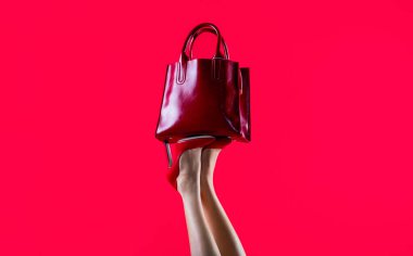 Yüksek topuklu ayakkabılar. Kırmızı deri çanta. Güzel bacaklı kadın. Şık kırmızı deri çanta. Yüksek topuklu giyen mükemmel kadın bacakları. Bacakları düzgün, yüksek topuklu bir kız. Kırmızı parlak kadın derisi