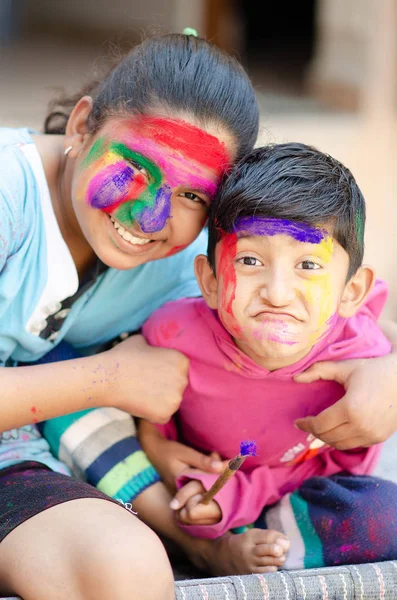 Jolis frères et sœurs adorables jouant avec les couleurs pendant le festival holi — Photo