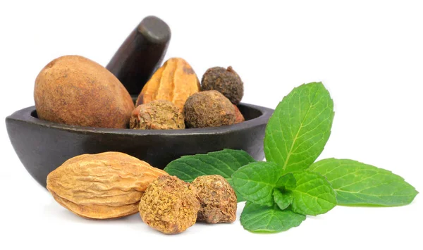 Triphala-a combination of ayurvedic fruits with mint leaves Stock Image