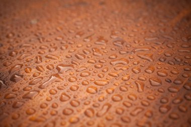 Bazı yağmur damlaları ahşap platformda bir kadeh yukarıya kapatmak.