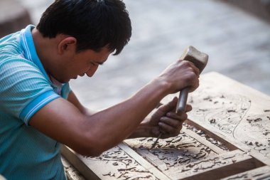 Buhara, Özbekistan - 1 Haziran 2017: Esnaf ahşap Buhara, Özbekistan'ın tarihi şehir içine bölmek.